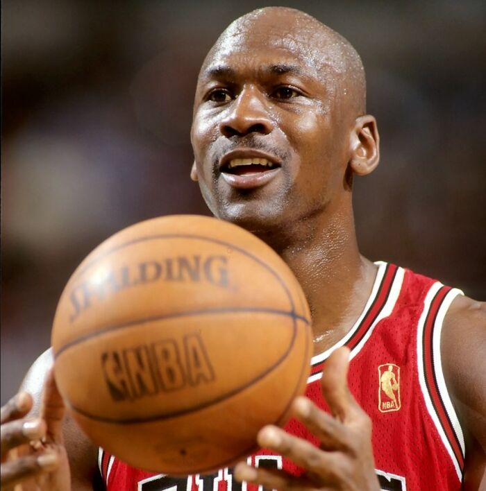 Basketball legend holding a Spalding NBA ball, one of the highest-value collectible items sold for millions.