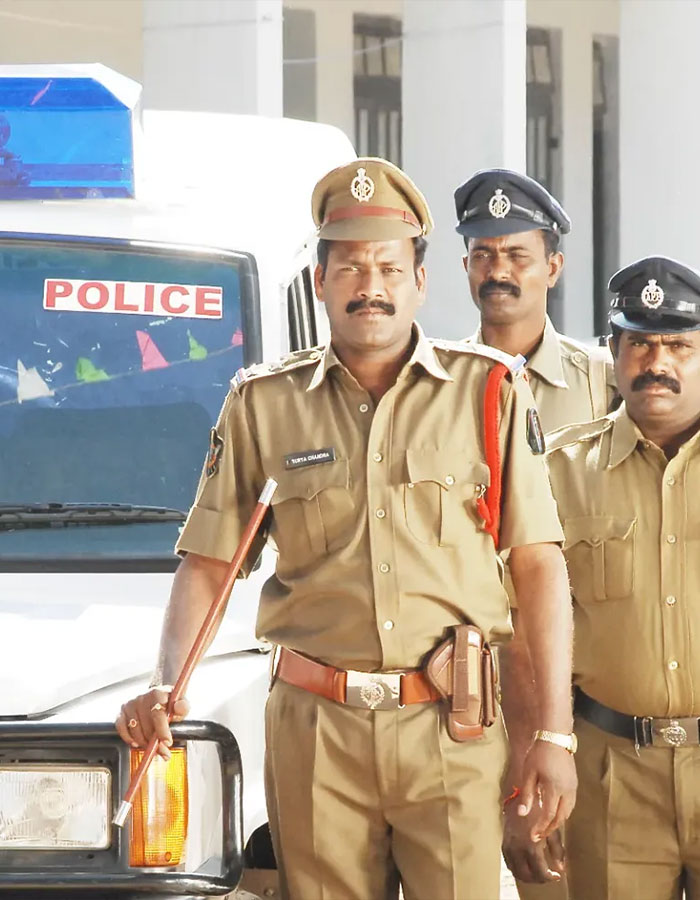 Three Indian police officers in uniform standing in front of a police vehicle representing male ego and tennis pro shooting case. Three Indian police officers in uniform standing in front of a police vehicle representing male ego and tennis pro shooting case.