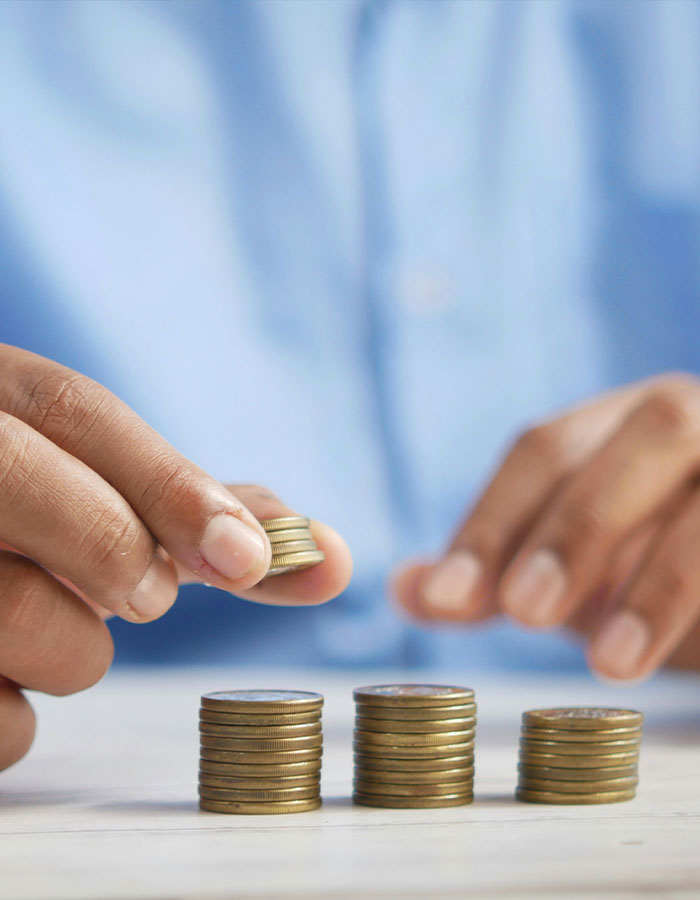 Close-up of a person stacking coins representing financial control and male ego in money management. Close-up of a person stacking coins representing financial control and male ego in money management.