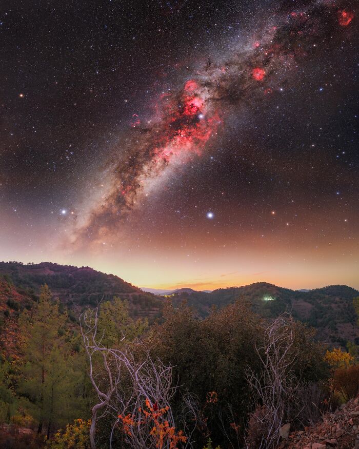 Vibrant space photo showing Milky Way and stars over a mountainous landscape, from the 2025 astronomy photographer shortlist.