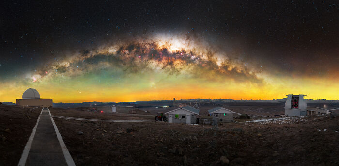 Panoramic view of observatory buildings under a vibrant star-filled sky showcasing breathtaking space photos from 2025 shortlist.