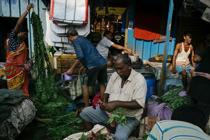Busy Indian street market scene with vendors handling fresh vegetables in a powerful street photo capturing the soul of India.