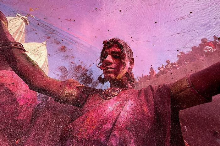 Street photo capturing a vibrant moment with colorful powders during an Indian cultural festival by photographer Rohit Vohra.