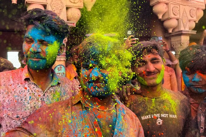 Men covered in vibrant colors celebrating Holi in a powerful street photo capturing the soul of India by Rohit Vohra