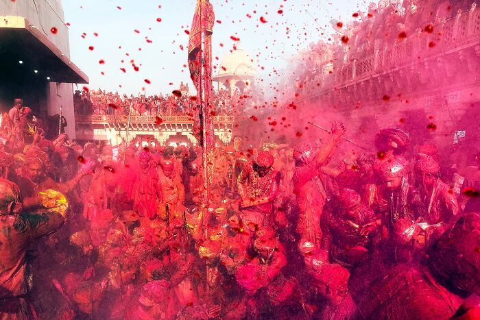 Crowd covered in vibrant colors during a lively street festival in India, capturing the soul through powerful street photos.