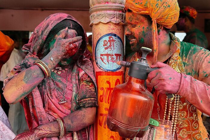Indian woman and man covered in colorful powder celebrating Holi in a powerful street photo capturing the soul of India.