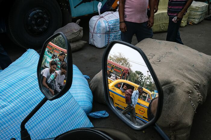 Reflections in mirrors showing street life and people, capturing the soul of India through powerful street photos.