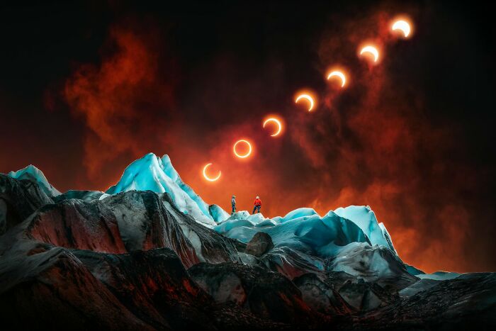 Breathtaking color photography showing a vibrant solar eclipse sequence over icy blue mountains with two explorers.