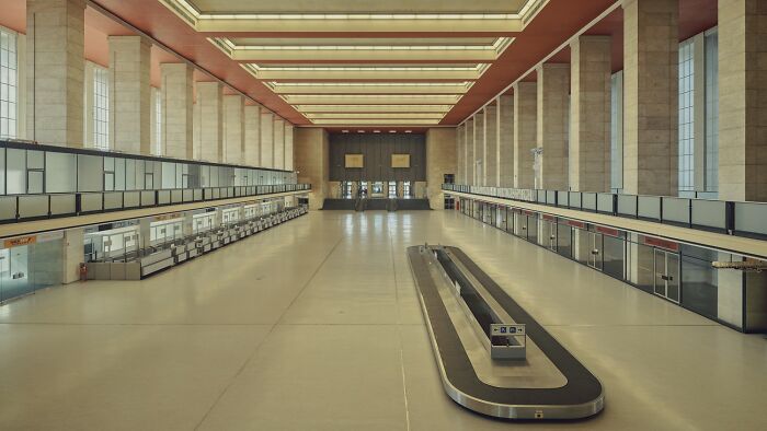 Spacious modern interior with check-in counters and baggage carousel showcasing exceptional color photography qualities.