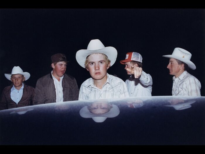 Five young men in cowboy hats and casual shirts at night, captured in striking color photography from the 2025 Refocus Awards.