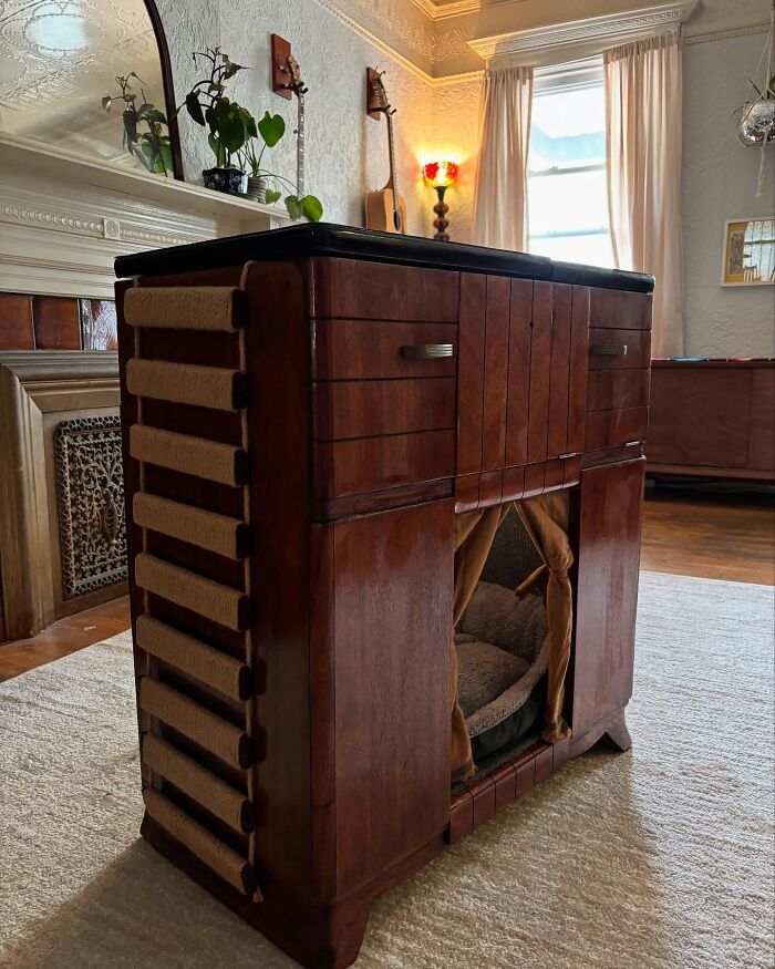 Vintage TV repurposed into a cozy cat bed with scratch pads, blending nostalgic nooks and pet comfort in a stylish living room.