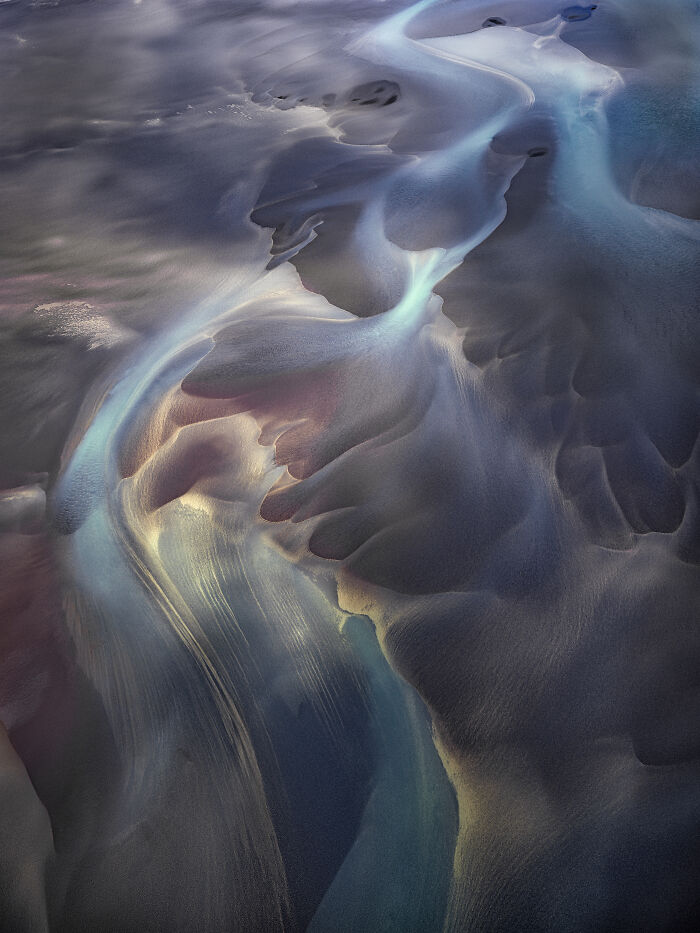 Abstract aerial shot of winding river in vibrant colors showcasing winning aerial shots photography.