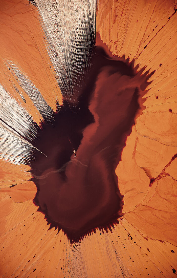 Aerial shot capturing abstract patterns and vibrant colors in a desert landscape from a winning photographer.