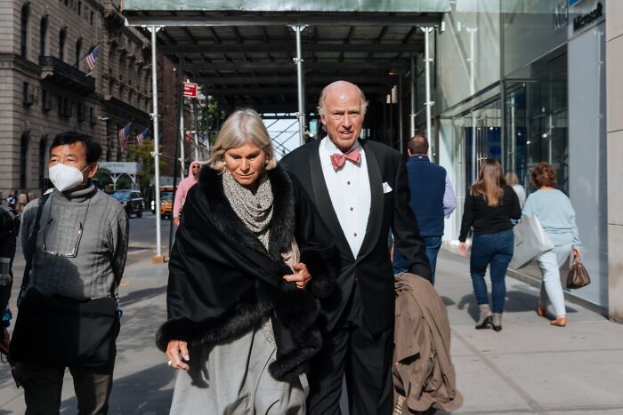 Elderly couple walking in NYC street captured in a powerful street moment by a New York City photographer.