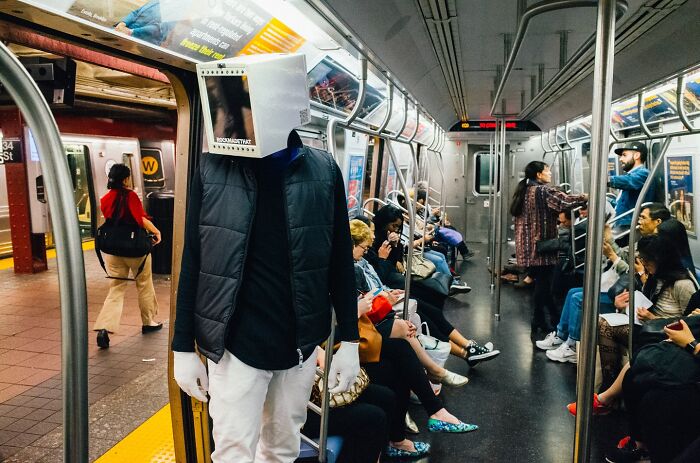 NYC street photo of subway passengers highlighting everyday life and candid moments in the city of endless stories.