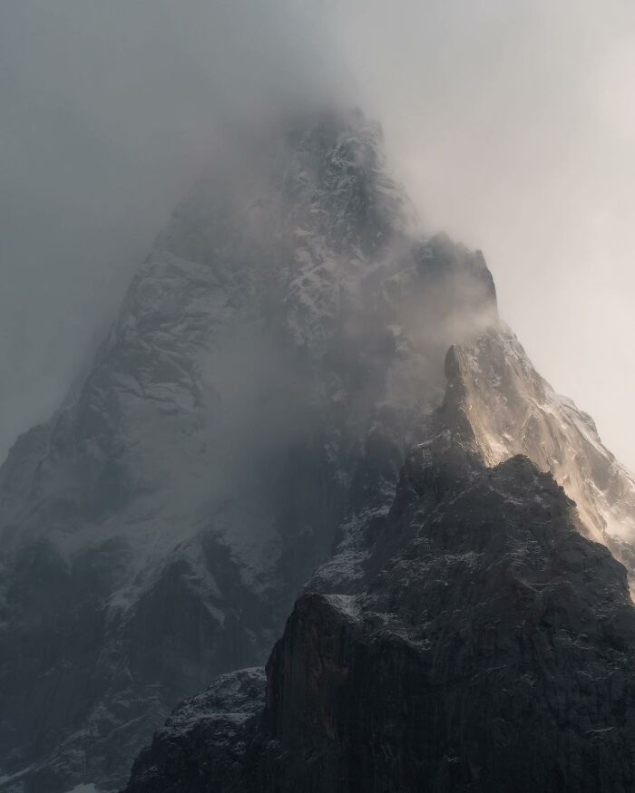 Misty mountain peak with rugged rocky landscape captured in breathtaking fantasy movie style photography.