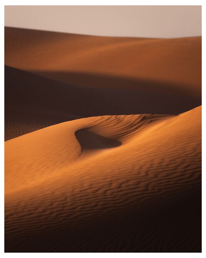 Breathtaking landscape shots of desert sand dunes with light and shadows creating a fantasy movie-like effect.