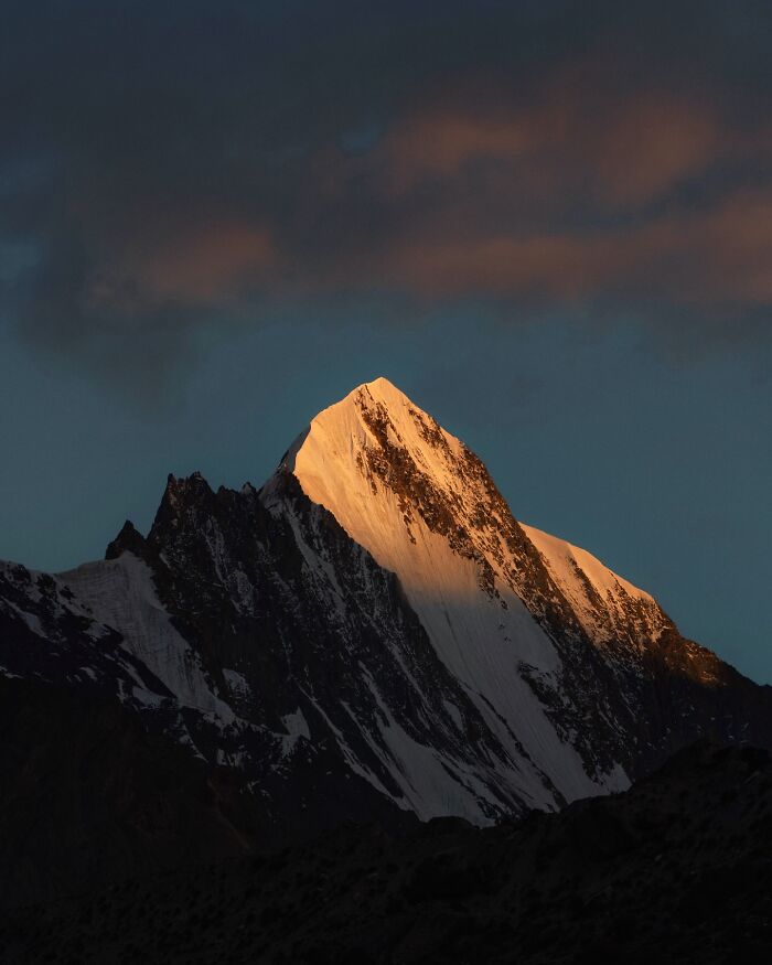 Snow-capped mountain peak glowing at sunset, showcasing breathtaking landscape shots resembling scenes from a fantasy movie.