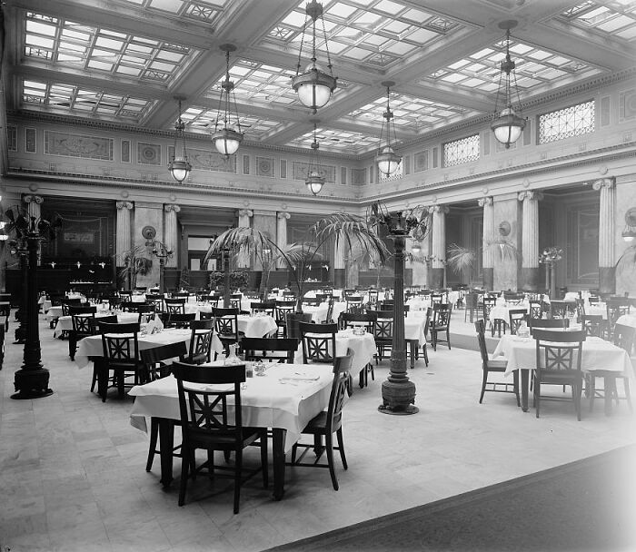 Vintage dining room in Washington D.C. from the 1920s featuring tables with white tablecloths in a grand hall