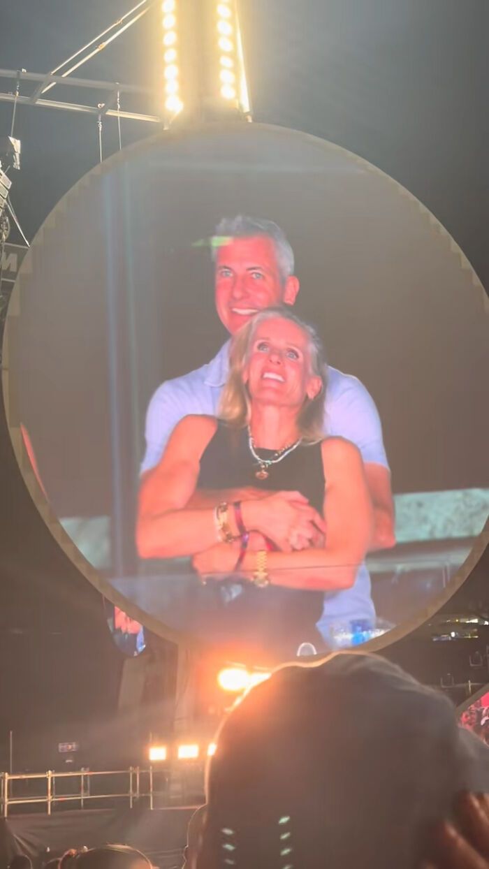 Couple awkwardly captured on kiss cam screen during baseball game as mascot mocks disgraced CEO scandal.