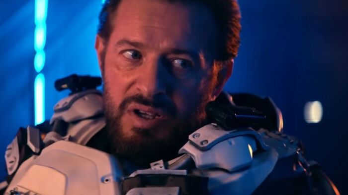 Actor in futuristic armor with intense expression, representing some of the worst movies in the hall of shame list.