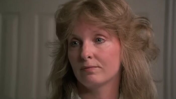 Close-up of a woman with blonde hair, expressing concern in a scene from one of the worst movies of all time.