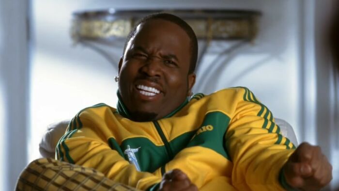 Actor in a yellow and green jacket making a grimacing face in a scene from one of the worst movies of all time.