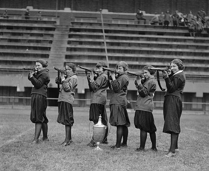 Women with rifles posing on a field with a trophy in Washington, D.C., vintage 1920s historical photo.