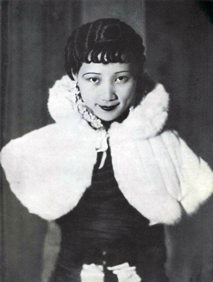 Black and white portrait of a woman from a century old photo showcasing timeless beauty and classic fashion style.