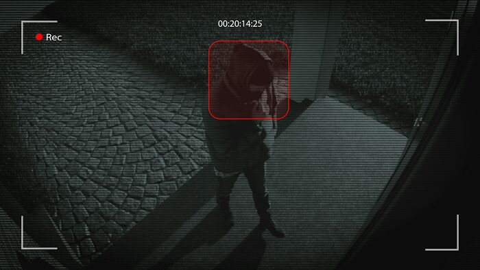 Person in a hooded jacket captured by night security camera, highlighting a strange case investigated by private investigators. - 13