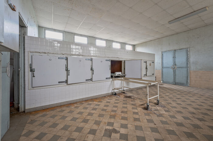 Empty hospital morgue with body storage drawers, illustrating scientists share use of bodies donated for science research.