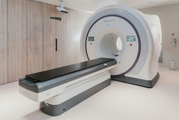 Modern medical imaging machine in a clinical room representing doctors and impostor patients in healthcare stories.