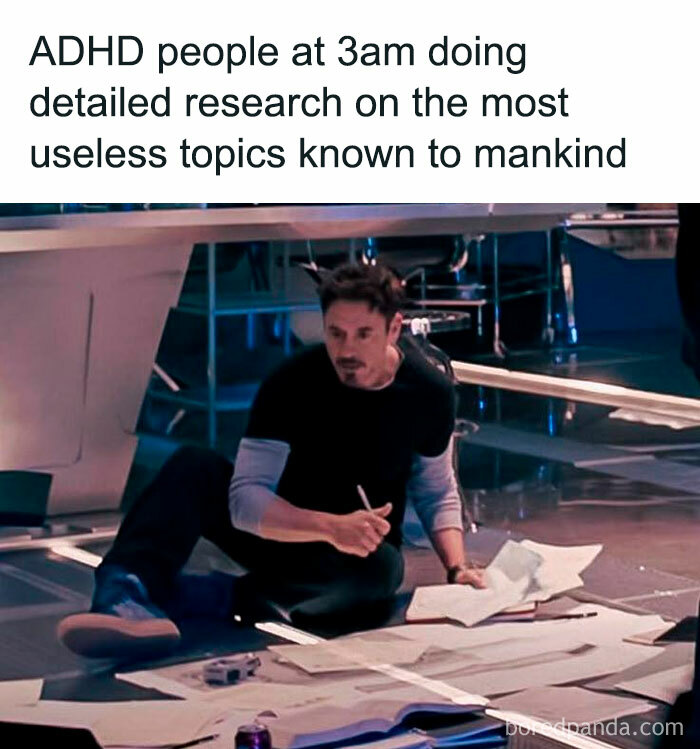 Man with papers on floor researching late at night, illustrating common behaviors relatable to neurodivergents and ADHD traits.