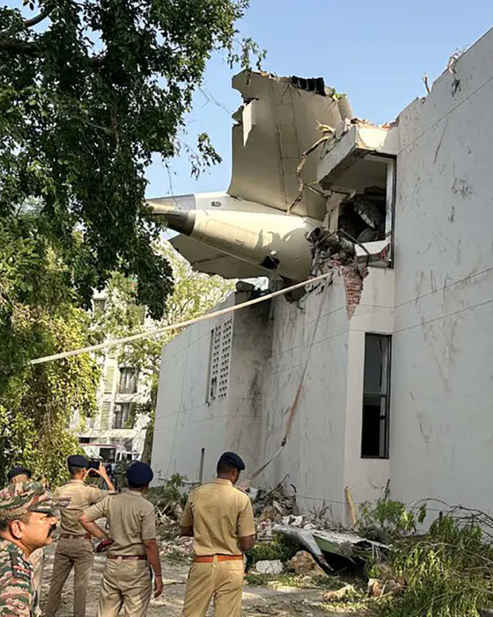 Police officers inspecting the Air India plane crashed into a building after the pilot deliberately shut off fuel.