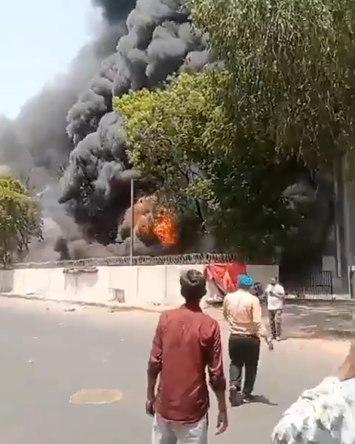 People observing thick black smoke and fire from an Air India crash site revealing cause and pilot final words.