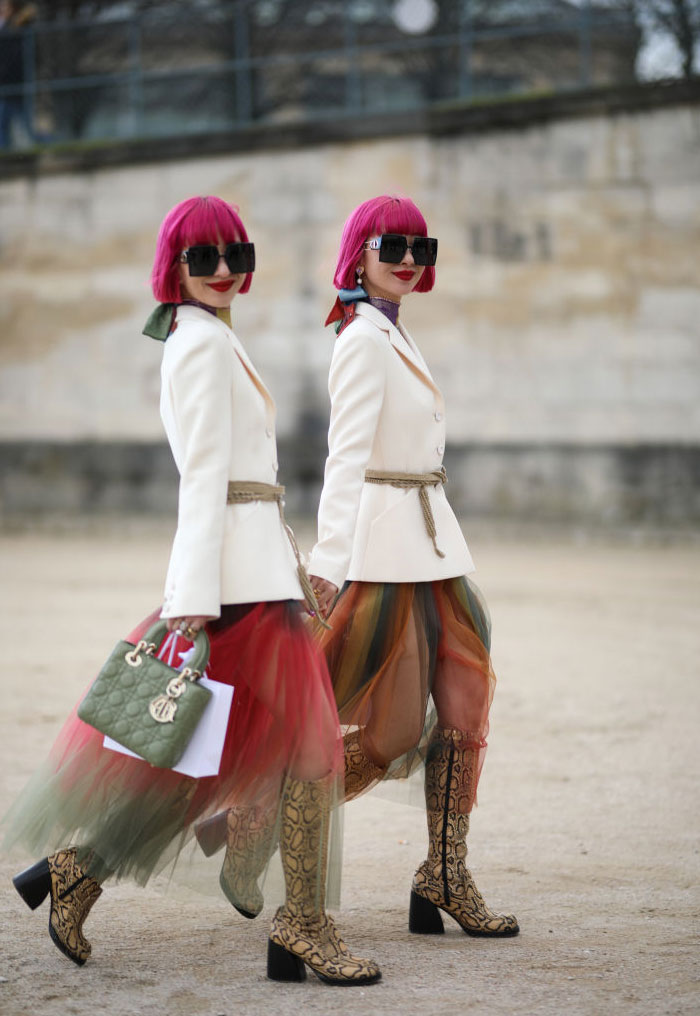 Ami Amiaya and Aya Amiaya with pink hair and oversized sunglasses wearing white blazers and colorful tulle skirts, representing air signs zodiac survival kit.