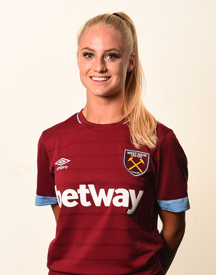 Female footballer in West Ham United jersey smiling, showcasing transformation of the world's prettiest footballer.