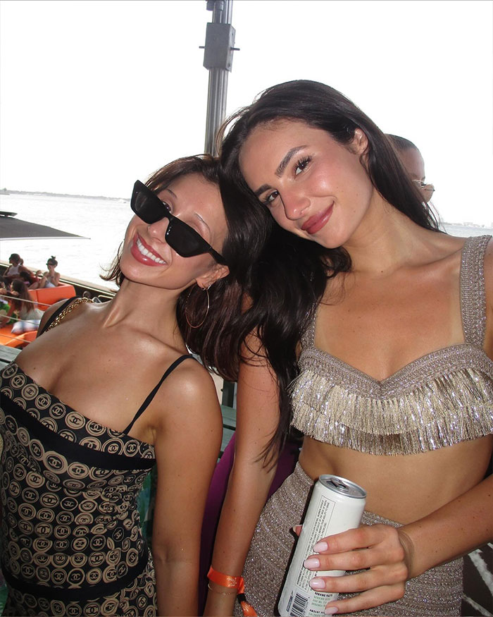 Two women including Alix Earle smiling and posing at an outdoor event, reflecting on Alix Earle net worth and lifestyle insights.