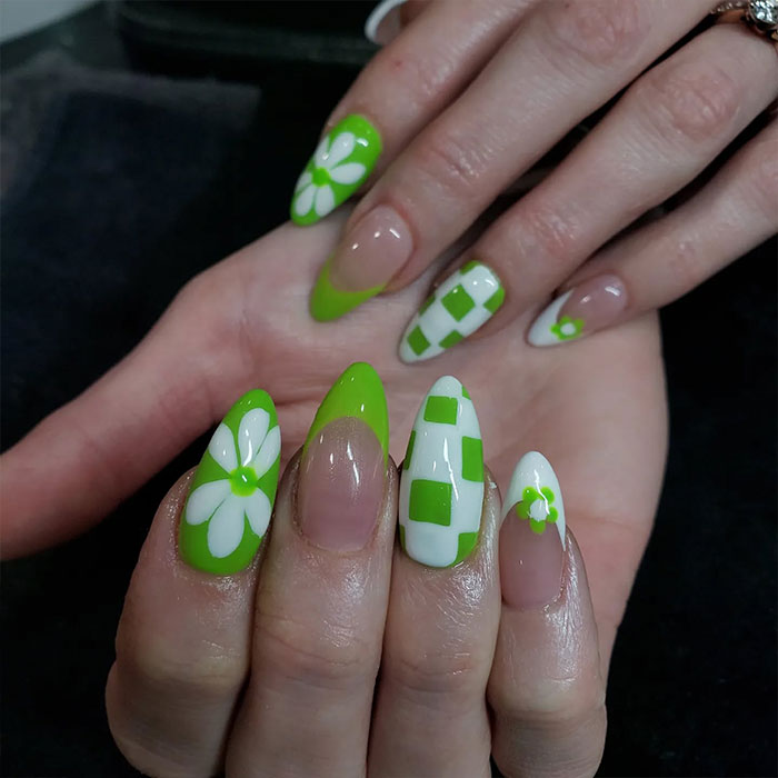 Almond nails with green and white floral and checkered designs showcasing popular almond nails trends for 2025.
