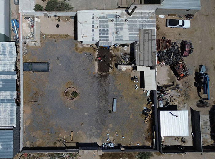 Aerial view of a mysterious building and yard where cops discover nearly 400 human bodies stacked inside. Aerial view of a mysterious building and yard where cops discover nearly 400 human bodies stacked inside.