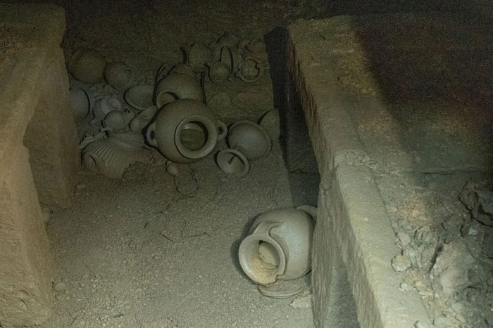 Ancient burial chamber inside 2,600-year-old tomb in Italy with pottery vessels uncovered by archaeologists.
