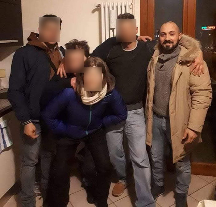 Group of friends posing indoors, connected by the story of the man sucked into a plane engine incident.