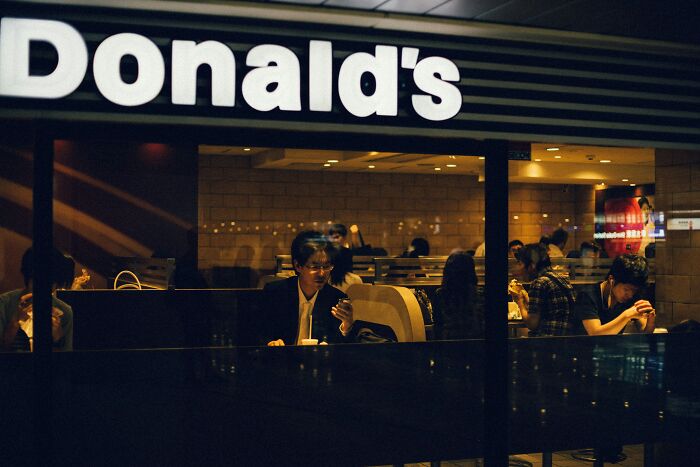McDonald's employees working inside a dimly lit restaurant sharing bizarre experiences with customers and coworkers.