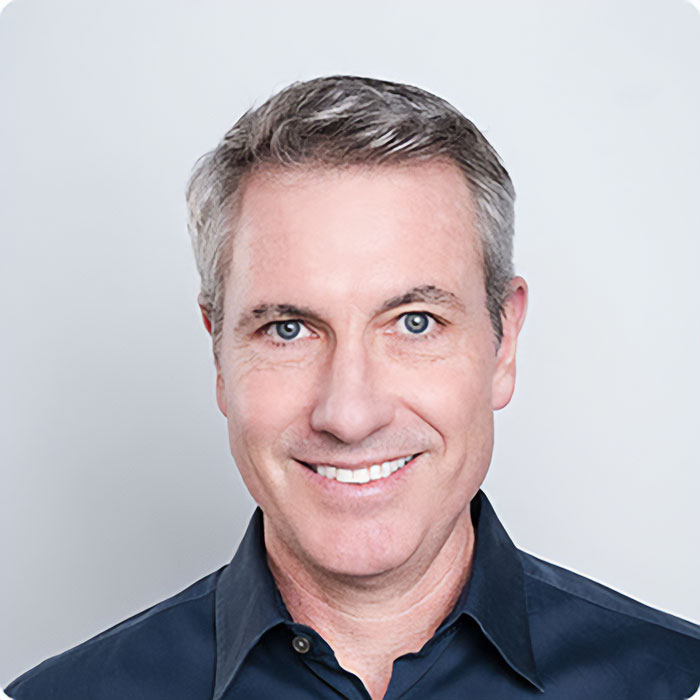 Smiling middle-aged man in a dark shirt representing HR executive linked to Coldplay cheating scandal and Boston's elite families.