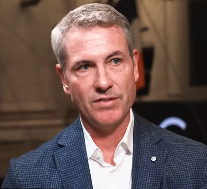 Astronomer CEO Andy Byron in a formal jacket speaking during an interview about recent Kiss Cam incident.