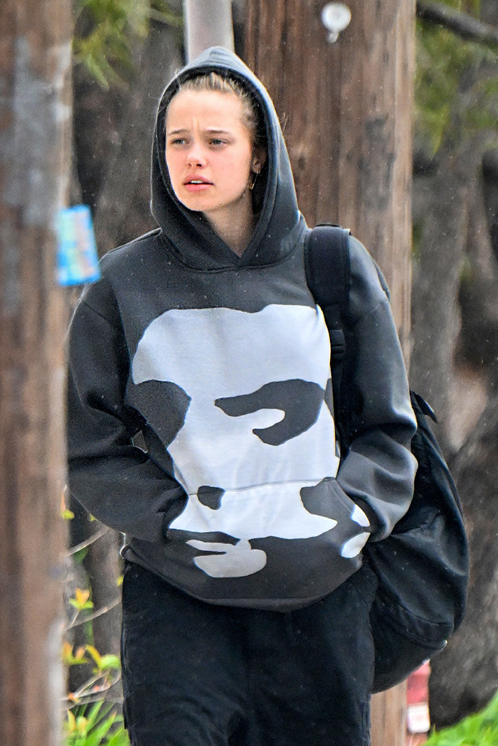 Shiloh Jolie-Pitt wearing a black hoodie and backpack during a casual public outing, fueling romance rumors.