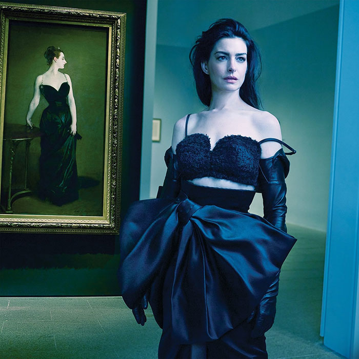 Anne Hathaway posing in a dramatic black outfit for a Vogue photoshoot amid fan backlash over the cover and style. Anne Hathaway posing in a dramatic black outfit for a Vogue photoshoot amid fan backlash over the cover and style.