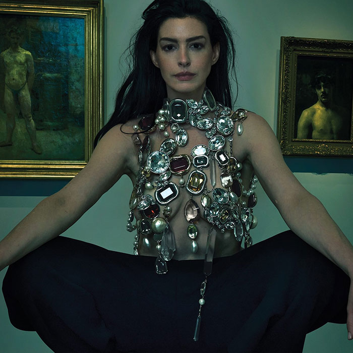 Anne Hathaway posing in a jewel-encrusted top for a Vogue photoshoot amid fan controversy over the cover and shoot style. Anne Hathaway posing in a jewel-encrusted top for a Vogue photoshoot amid fan controversy over the cover and shoot style.