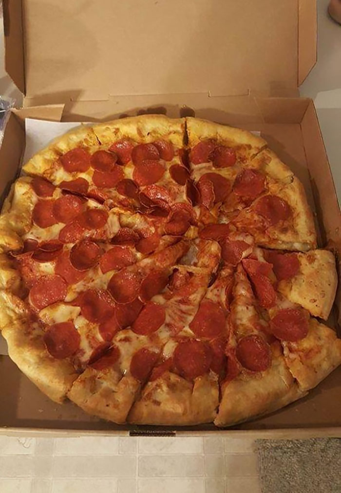 Pepperoni pizza with unevenly cut slices in a box, illustrating imperfect things that annoy people with OCD.