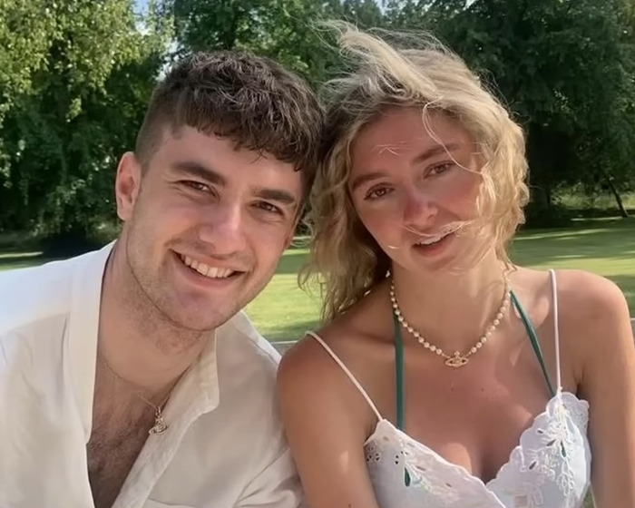 Young man and woman outdoors with trees in the background, related to anti-vax woman refusing chemotherapy story.